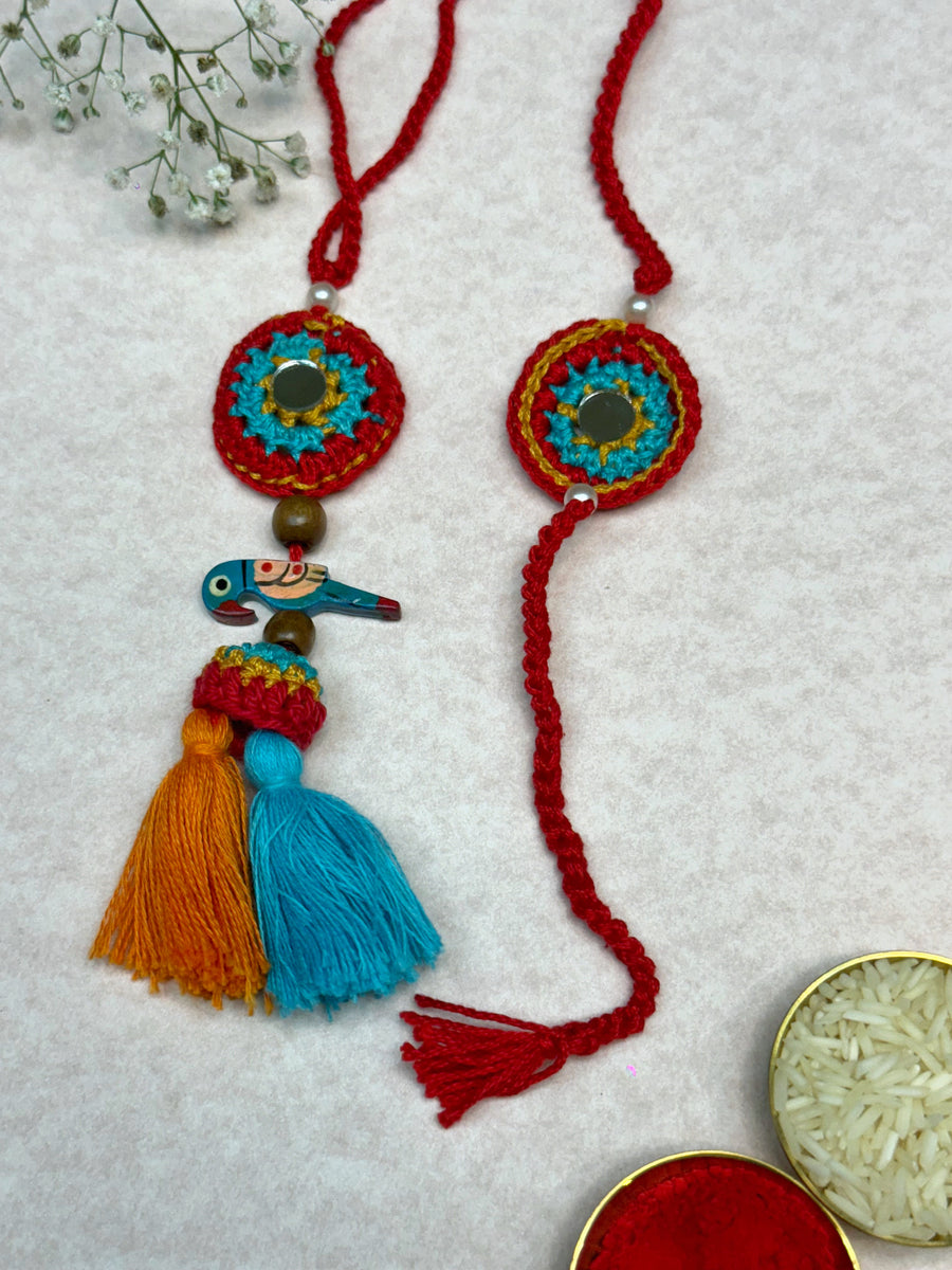 Parrot Petal Duo – Handcrafted Mirror & Parrot Crochet Rakhi Set