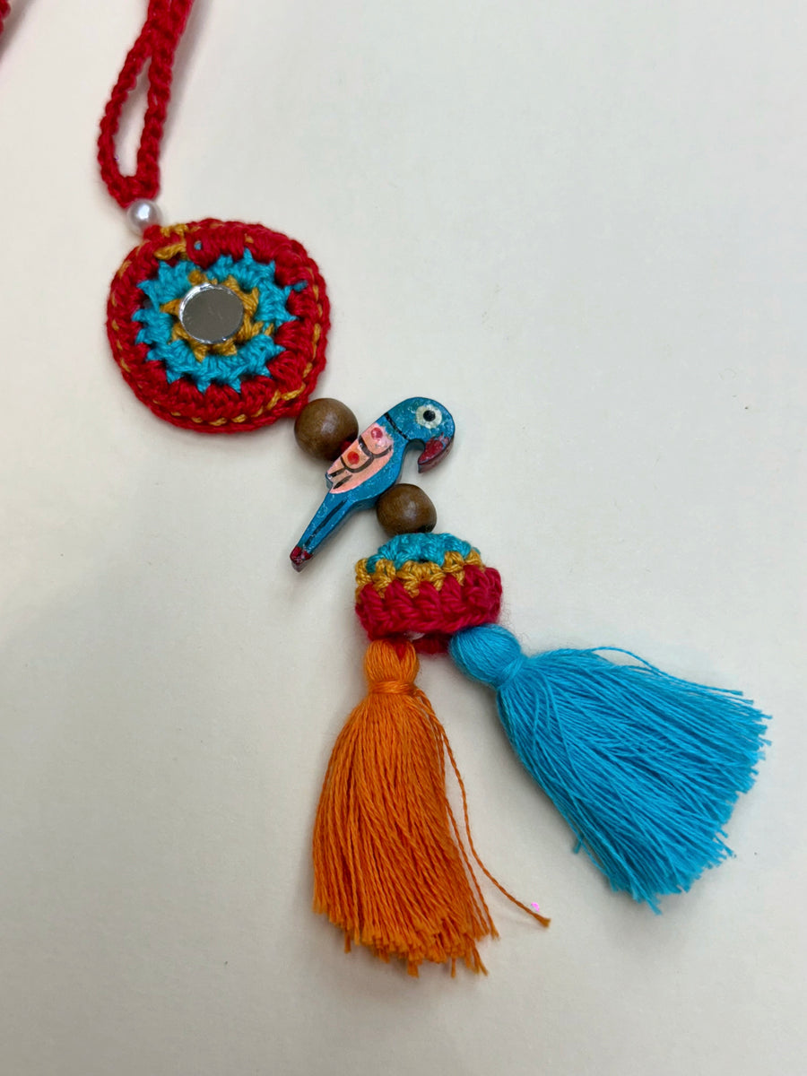 Parrot Petal Duo – Handcrafted Mirror & Parrot Crochet Rakhi Set
